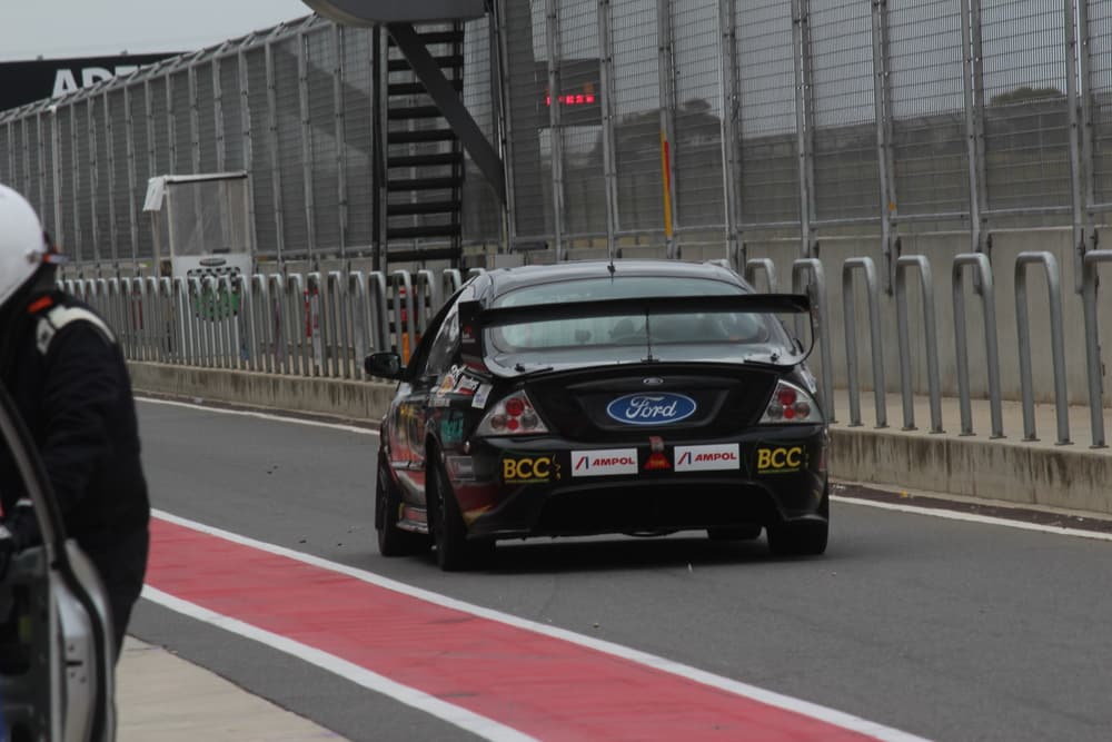 Race sedan waiting in pit lane