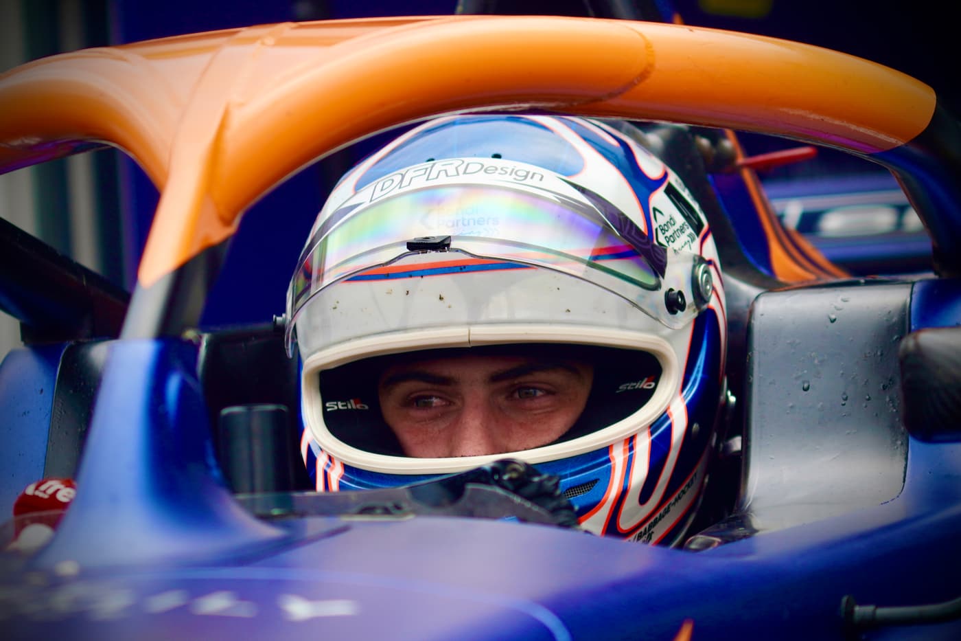 Driver in the halo cockpit of a formula car before a session