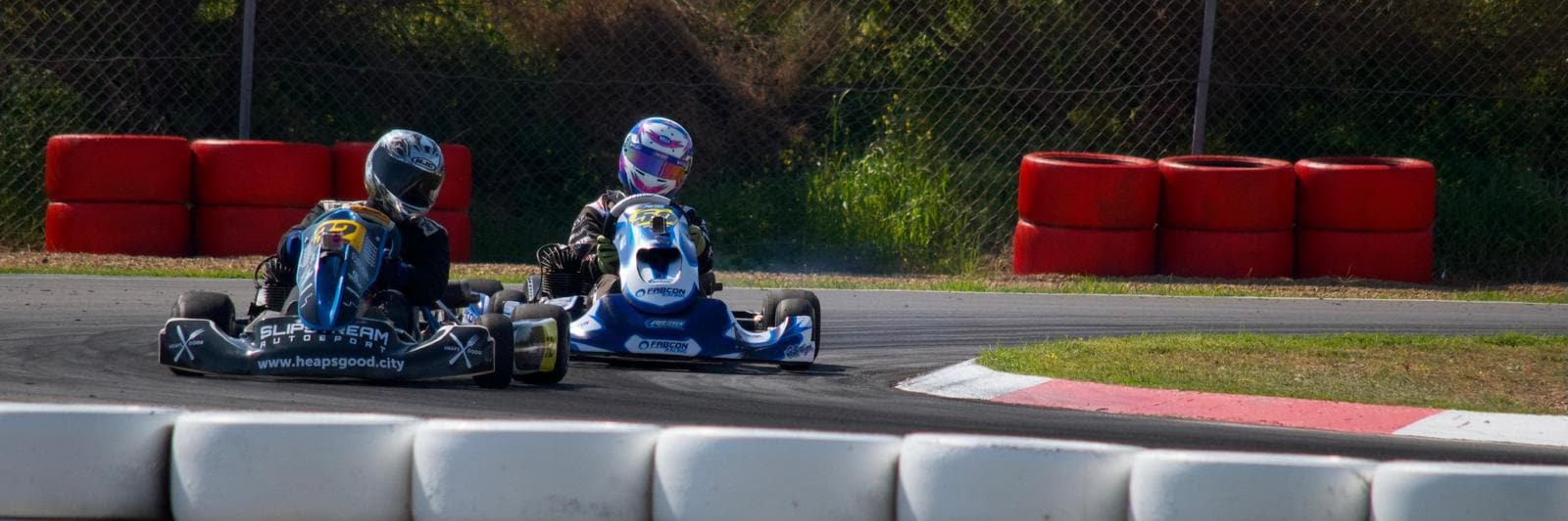 Racing kart attacking a kerb with smoke off the tyre