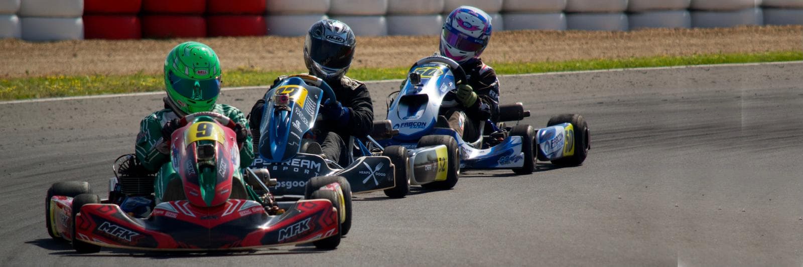 Pack of racing karts fighting through a corner