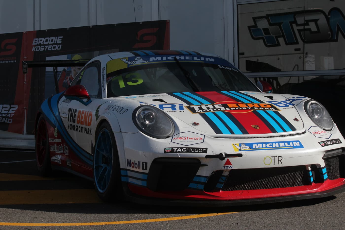 Martini-liveried Porsche Cup car in the paddock