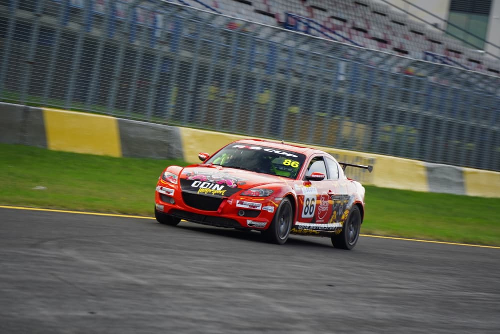 Orange RX8 race car on track