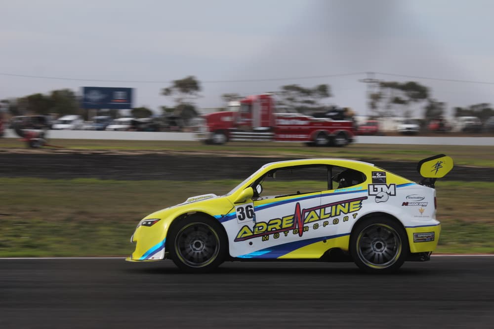 Yellow sports sedan on track