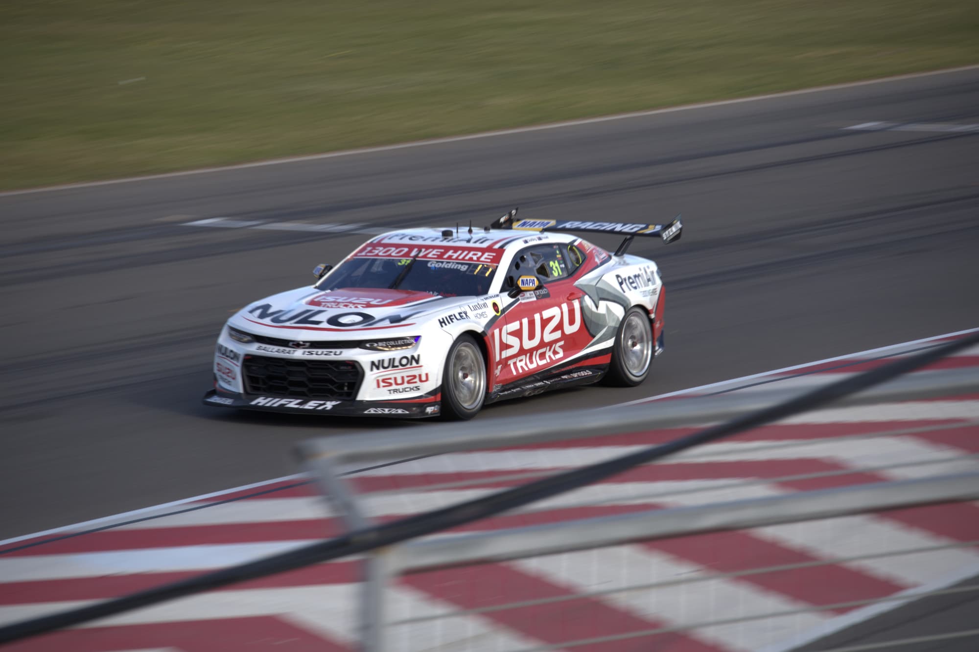 Supercar riding the checkered kerb at full lean