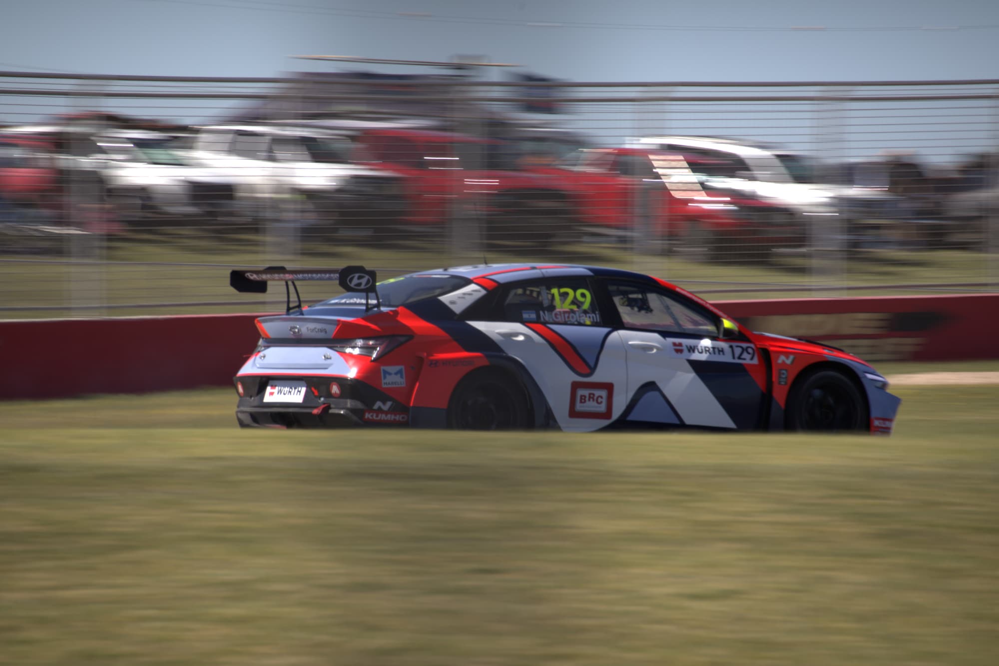 Touring car attacking the kerb mid-corner