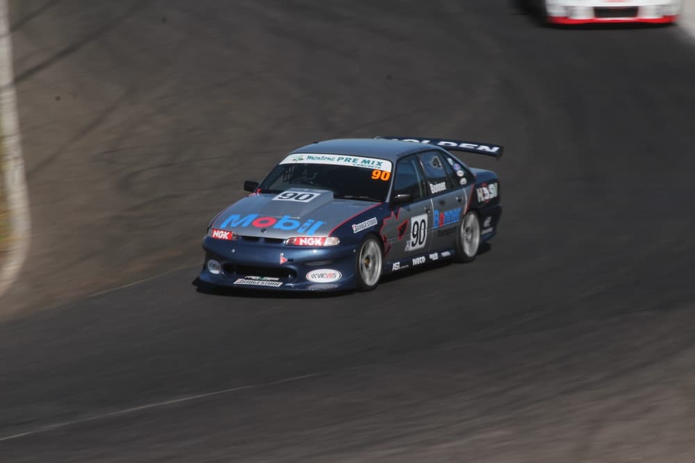 V8 sedan race car on track
